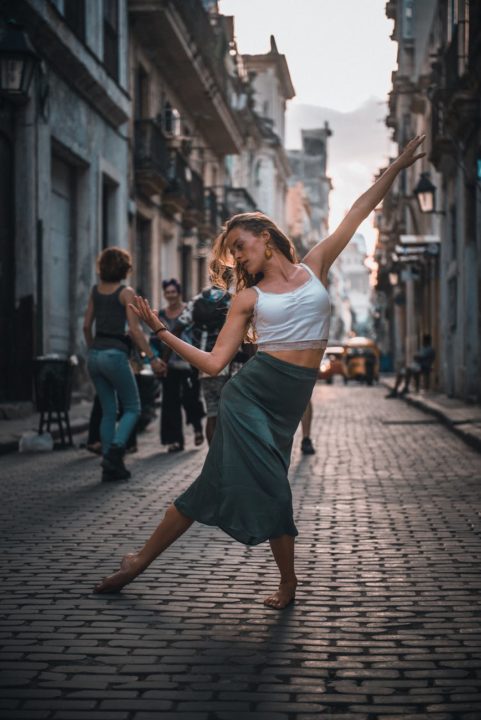 https://www.pexels.com/photo/photo-of-a-woman-dancing-on-a-street-2406676/