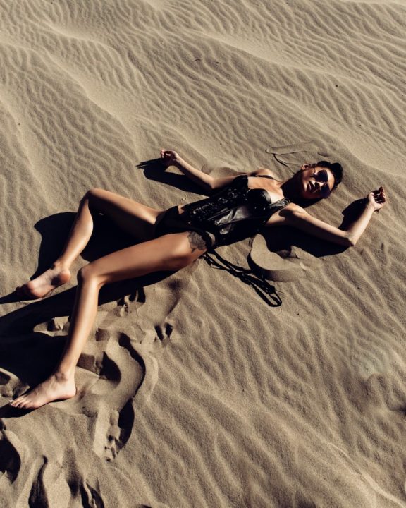 https://www.pexels.com/photo/woman-lying-on-sand-2779369/