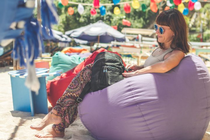 https://www.pexels.com/photo/woman-wearing-gray-tank-top-sitting-on-purple-bean-bag-1022487/