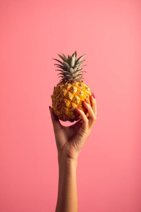 https://www.pexels.com/photo/person-holding-pineapple-fruit-2940256/