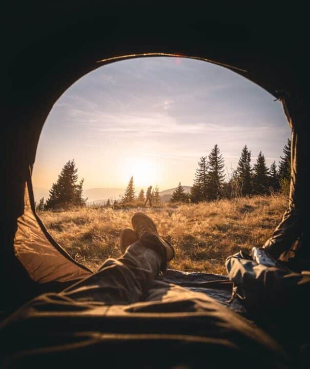https://www.pexels.com/photo/person-lying-inside-the-tent-through-the-grass-field-under-the-golden-hour-3367618/