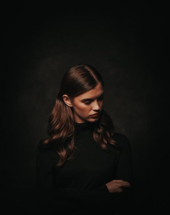 https://www.pexels.com/photo/photo-of-woman-in-black-turtleneck-sweater-posing-in-front-of-black-background-while-looking-away-3199036/