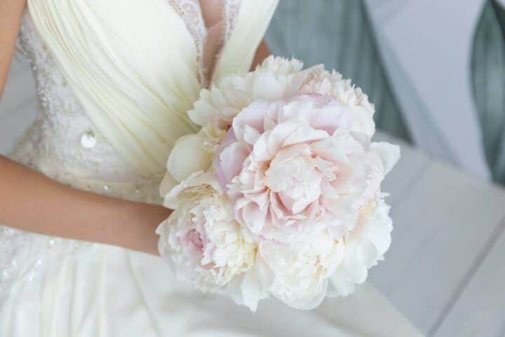 https://www.pexels.com/photo/woman-in-white-floral-dress-holding-pink-flower-bouquet-4691850/