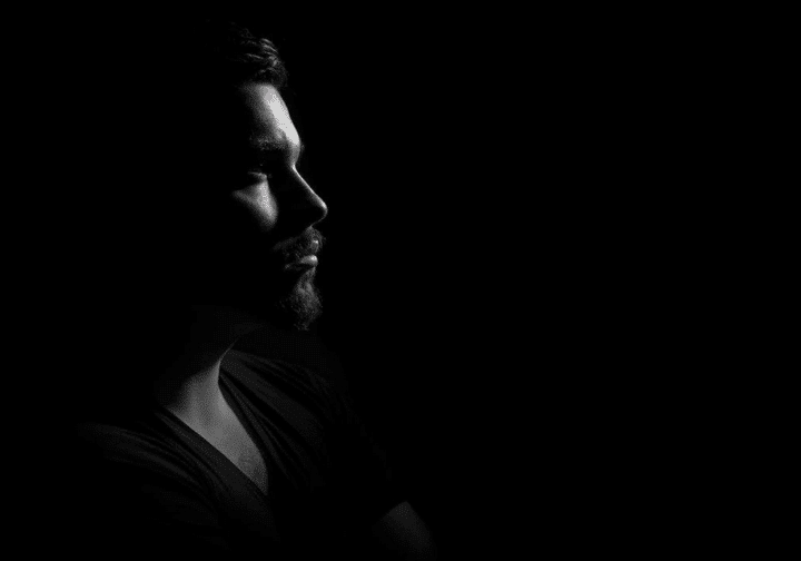 https://www.pexels.com/photo/grayscale-photo-of-man-in-black-v-neck-shirt-with-black-background-90764/