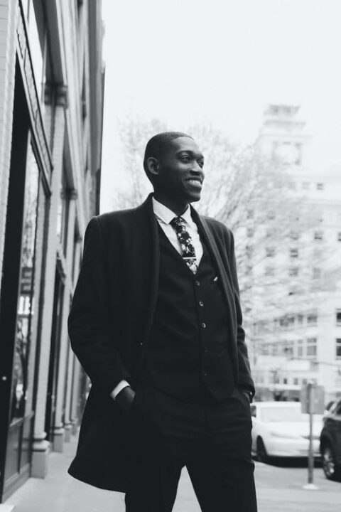 https://www.pexels.com/photo/black-stylish-man-in-suit-standing-on-street-4947748/