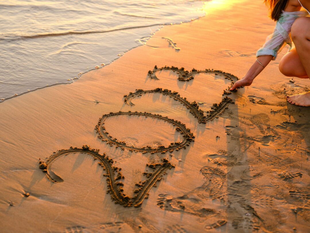 Best of 2023 - Woman draws a 2023 on the beach