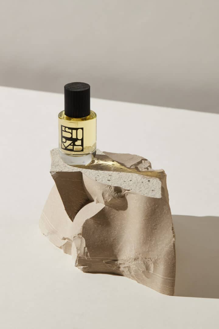 Antal by Estoras perfume bottle, simply staged on a light-colored block of natural stone against a neutral background - a symbol of clarity and strength