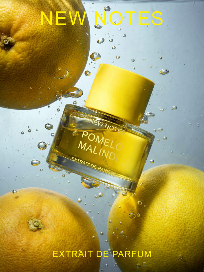 Flacon of Pomelo Malindi Extrait de Parfum by New Notes, surrounded by juicy pomelos and floating water bubbles in a fresh, citrusy underwater scene.